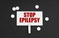 On a black background, there are pills and a business card with the inscription - STOP EPILEPSY