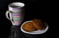 Cup with tea and two oatmeal cookies on a black background Royalty Free Stock Photo
