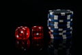 On a black background, two red dice and a bet for the game Royalty Free Stock Photo