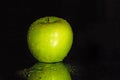 Black Background with a Wet Green Apple Royalty Free Stock Photo