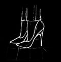 On a black background, a white image of women`s feet in high-heeled shoes Royalty Free Stock Photo