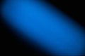 On a black background wide diagonal blurred textural beam of blue color