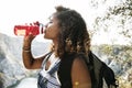 Black backpacker woman drinking water
