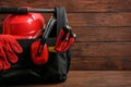 Black bag with construction tools on table against wooden background Royalty Free Stock Photo