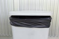 Black bag plastic in white trashcan Royalty Free Stock Photo