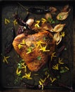 Oven roasted turkey breast with forsythia edible flowers, onions and chili.