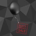 Black balloon on black polygonal background with inscription fo