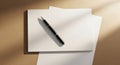 Black ballpoint pen resting on a blank grid paper notebook with soft light and shadow patterns Keywords: pen Royalty Free Stock Photo