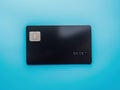 Black bank card on blue background isolated AI