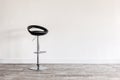 Black bar stool in front of wall. Royalty Free Stock Photo