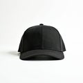 Black baseball cap on white background. Front view of plain black hat with curved brim and button on top. Black cap mockup for Royalty Free Stock Photo