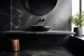 Black bathroom interior design, countertop washbasin and faucet on black marble counter, round mirror and wooden stool in modern Royalty Free Stock Photo