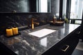 Black bathroom interior design, undercounter washbasin with black marble counter, modern luxury minimalist masculine washroom. Royalty Free Stock Photo