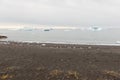 Black beach and icebergs