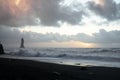 Black beach and troll rocks December, 10 in Vik village, Iceland. wildlife, volcanic black sand on the beach. setting sun on ocean Royalty Free Stock Photo