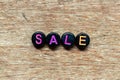 Black bead with letter in word sale on wood background
