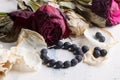 Black beads with dry roses Royalty Free Stock Photo