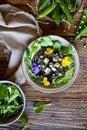 Black bean pasta salad with leafy greens, olives, green peas, sheep cheese and edible flowers