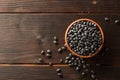 Black beans in ceramic bowl on dark wooden background Royalty Free Stock Photo