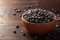 Black beans in ceramic bowl on dark wooden background Royalty Free Stock Photo