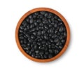 Black beans in wooden bowl isolated on white background. Top view Royalty Free Stock Photo