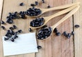 Black beans in wooden spoon and note paper. Royalty Free Stock Photo