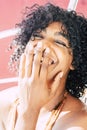 Black beautiful young woman laugh a lot in close up portrait - afro american woman have fun and enjoy laughing crazy - people