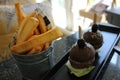 Black Beef Burgers with Chunky French Fries Royalty Free Stock Photo