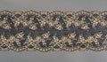 Color straight strip of lace fabric on a gray background. Elastic silk nylon braid border. use for clothes and linen decoration Royalty Free Stock Photo