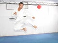 Black belt karate man jumping to give a high kick Royalty Free Stock Photo