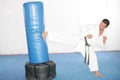 Black belt Karate man practicing in a sandbag