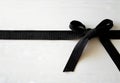 A black belt tied up on a white wooden surface Royalty Free Stock Photo