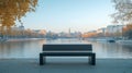 A Black Bench Facing a River with a City Skyline in the Background Royalty Free Stock Photo