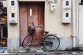 Black bicycle park in front of an old rustic door Royalty Free Stock Photo