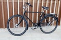 Black bicycle supported on a modern wall