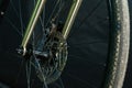 A black bicycle wheel with a tire close-up on a black background. Maintenance and repair of bicycles before responsible Royalty Free Stock Photo