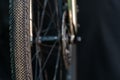 A black bicycle wheel with a tire close-up on a black background. Maintenance and repair of bicycles before responsible Royalty Free Stock Photo