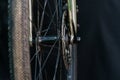 A black bicycle wheel with a tire close-up on a black background. Maintenance and repair of bicycles before responsible