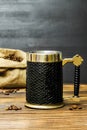 Black big cup mug with espresso coffee hot beverage,coffee beans in burlap bag on kitchen table. Royalty Free Stock Photo