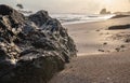 Black big rock lying on a beach in Africa`s gold coast Royalty Free Stock Photo