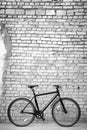 Black bike against brick wall Royalty Free Stock Photo