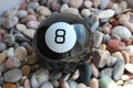 Black Billiard Ball Number Eight Lying On A Colored Smooth Pebbles Top View Royalty Free Stock Photo