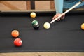 Black billiard table, Playing billiard - Close-up shot of a man playing billiard Royalty Free Stock Photo