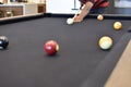 Black billiard table, Playing snooker pool 8ball - Close-up shot of a man playing billiard Royalty Free Stock Photo