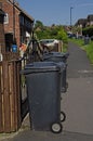 Black bin on pavement collection day Royalty Free Stock Photo