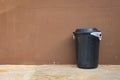 Black bin and wall on road Royalty Free Stock Photo