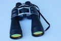 black binoculars lies on a gray table Royalty Free Stock Photo