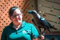 Black bird and a zoo keeper at a bird show at the John Ball Zoo in Grand Rapids Michigan