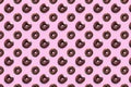 Black bited donuts with red glaze on pink background seamless pattern top view. Food dessert flatly flat lay of