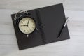 Black blank page paper book with pen and retro black alarm clock Royalty Free Stock Photo